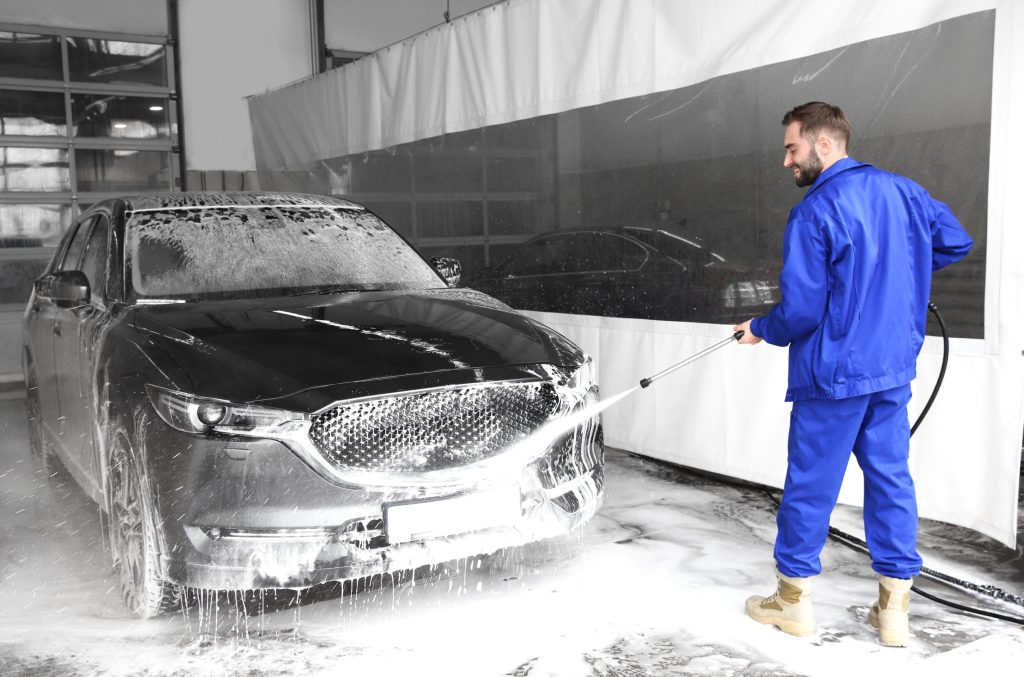 Auto detailer washing a car.
