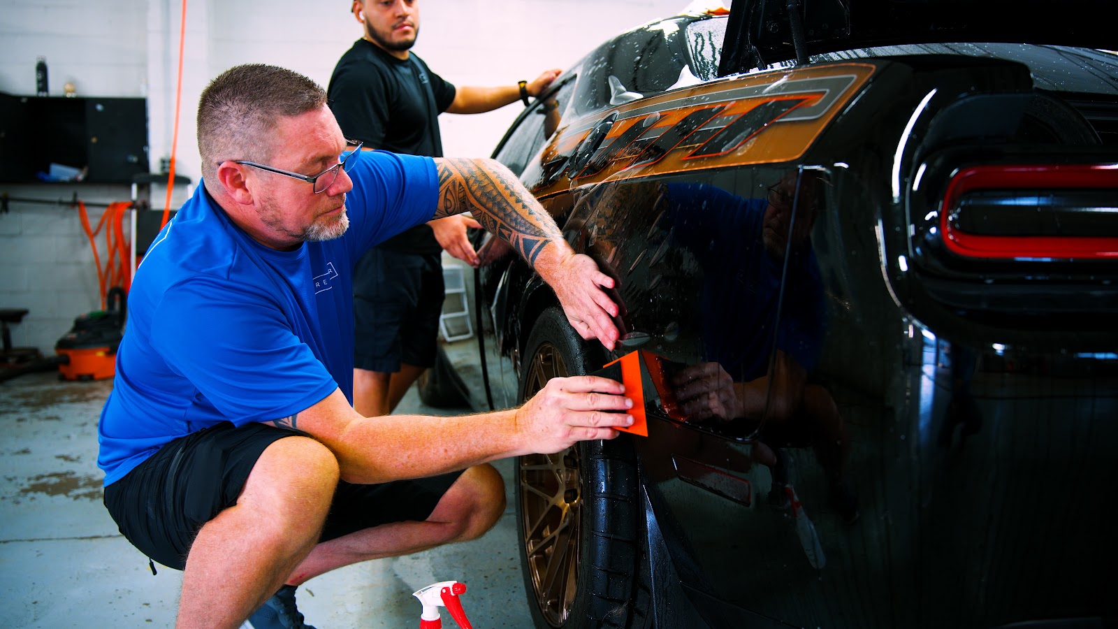 Premier team applying paint protection film